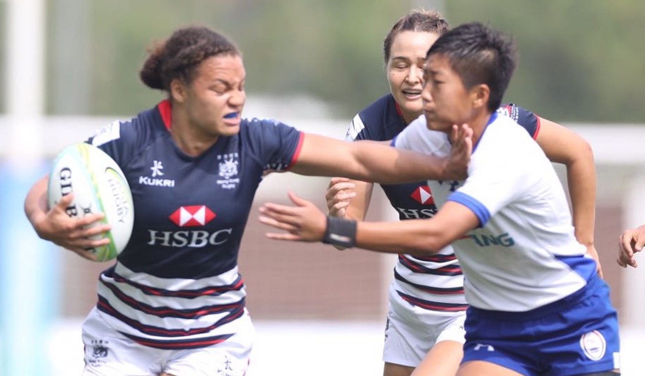 Natasha Olson-Thorne fends off an opponent during the first round of the Asia Women's Rugby Sevens Series.