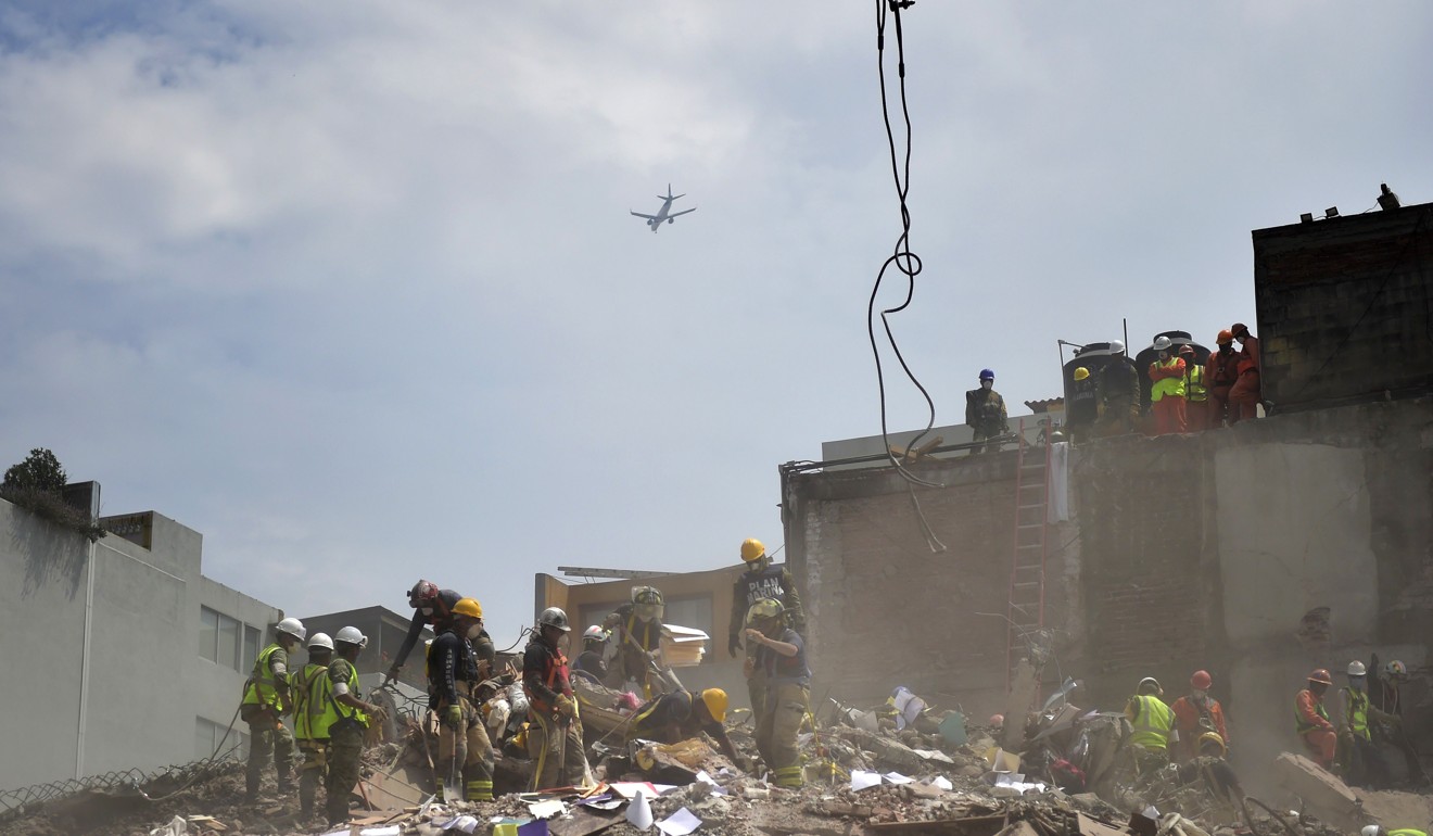 Rescuers work in a building demolished by a magnitude 7.1 quake that struck central Mexico. Photo: AFP