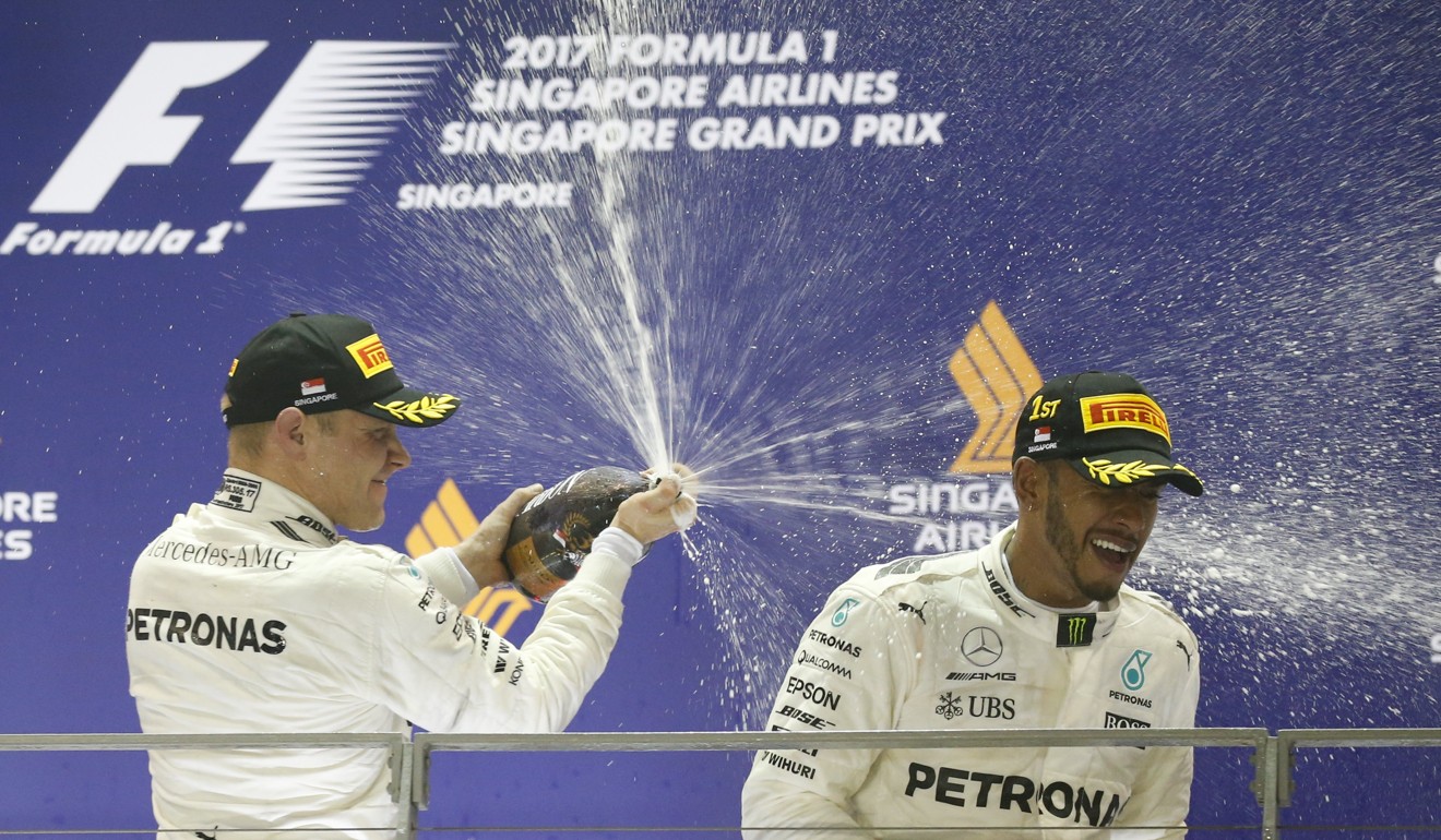 Lewis Hamilton celebrates with his teammate Valtteri Bottas after the Singapore Formula One Grand Prix. Photo: EPA