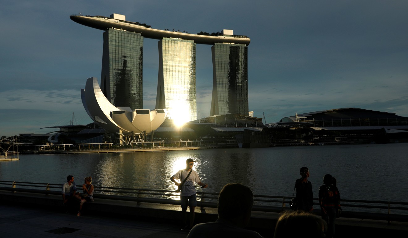 People relax along Marina Bay in Singapore on September 21. Singapore was – and is – very dependent on the water supply from Malaysia. Photo: Reuters