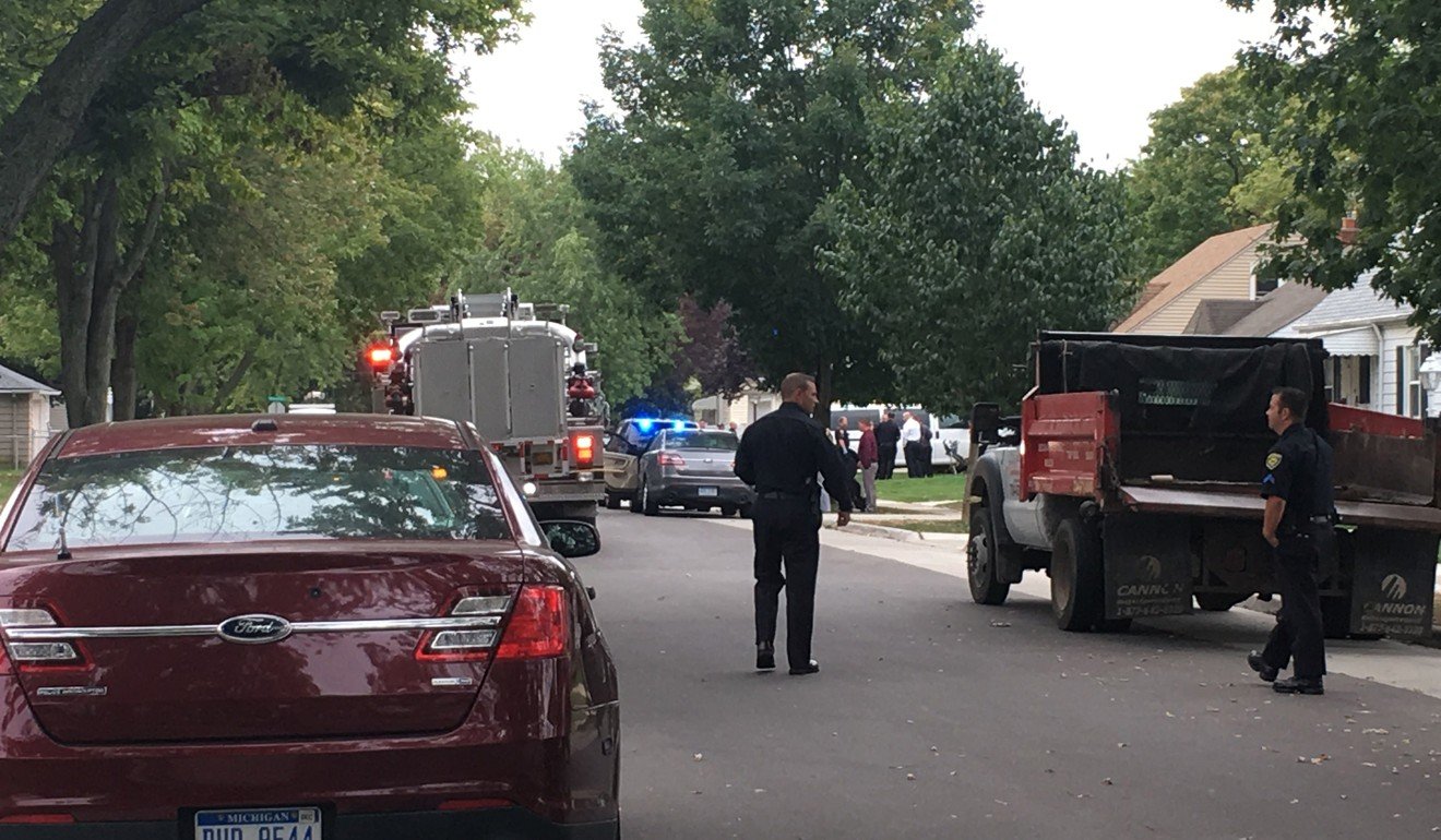 Dearborn police and fire officials block a road in Dearborn where two children were shot on Wednesday. Photo: TNS