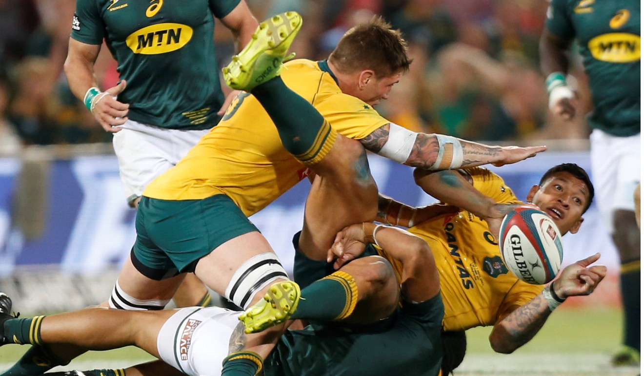 Israel Folau is crunched in a tackle. Photo: Reuters