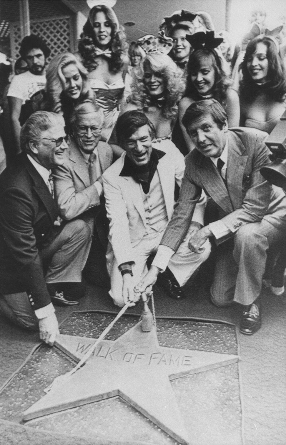 Monty Hall (right) presents a star on the Hollywood Walk of Fame in Los Angeles to Playboy founder Hugh Hefner (centre) in 1980. File photo: AP