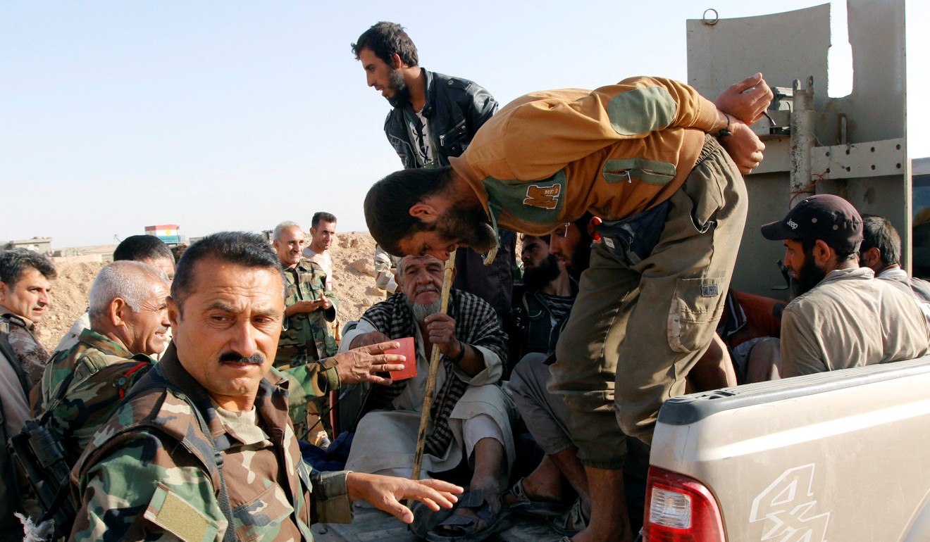 Kurdish Peshmerga forces detain Islamic State militants outside Hawija on Thursday. Photo: Reuters