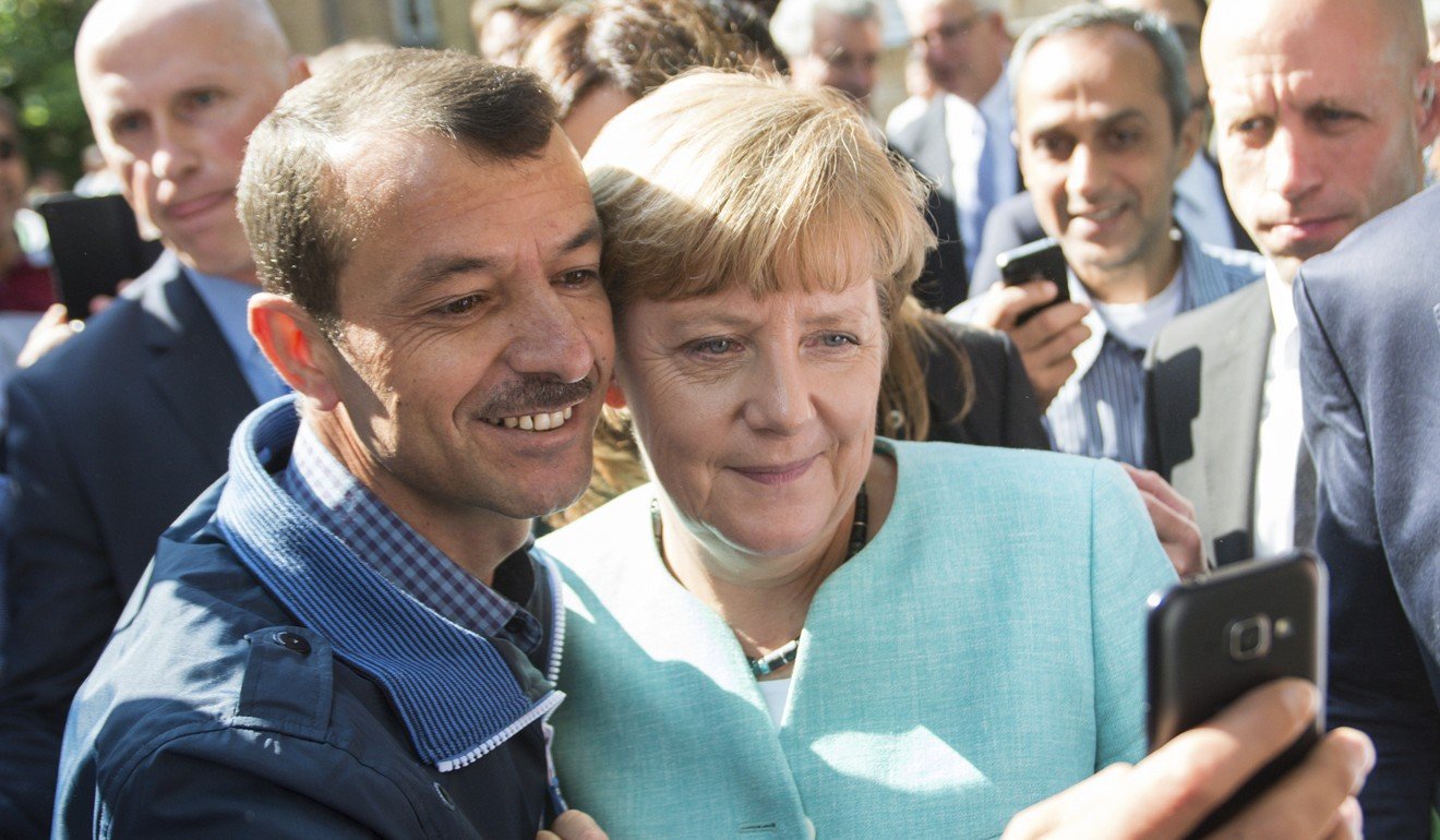 German Chancellor Angela Merkel takes a selfie with a refugee in Berlin. File photo: AP