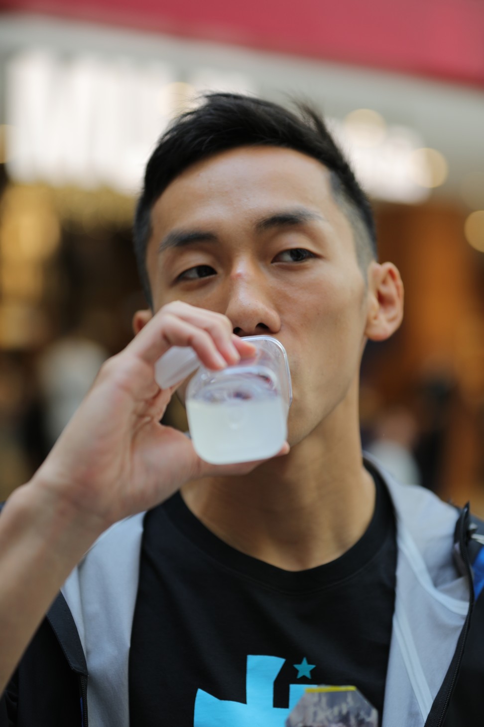 Rex Tso takes a sip from a recovery drink after making weight.