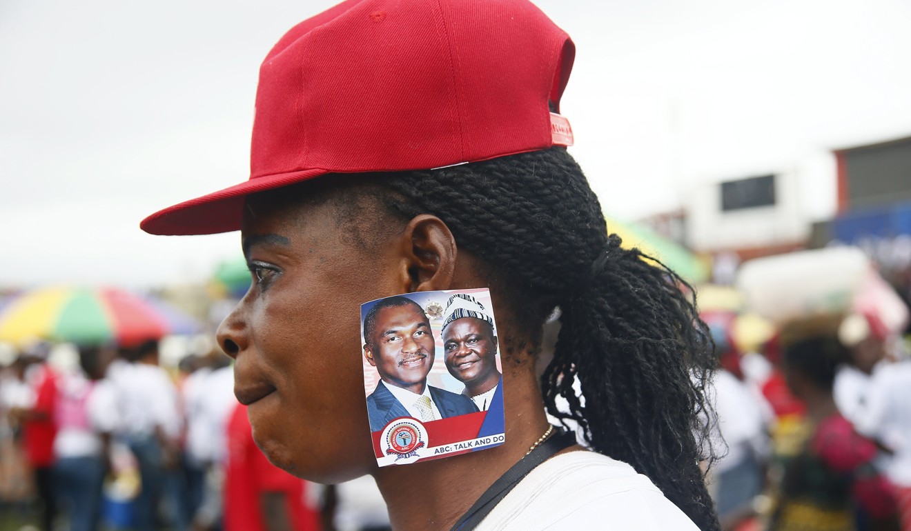 A supporter of Liberian presidential candidate Alexander B. Cummings at a rally in Monrovia on Monday. Photo: EPA