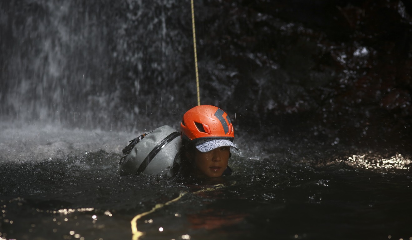 Huot swims to the edge of a natural pool after abseiling down a waterfall. Photo: James Wendlinger
