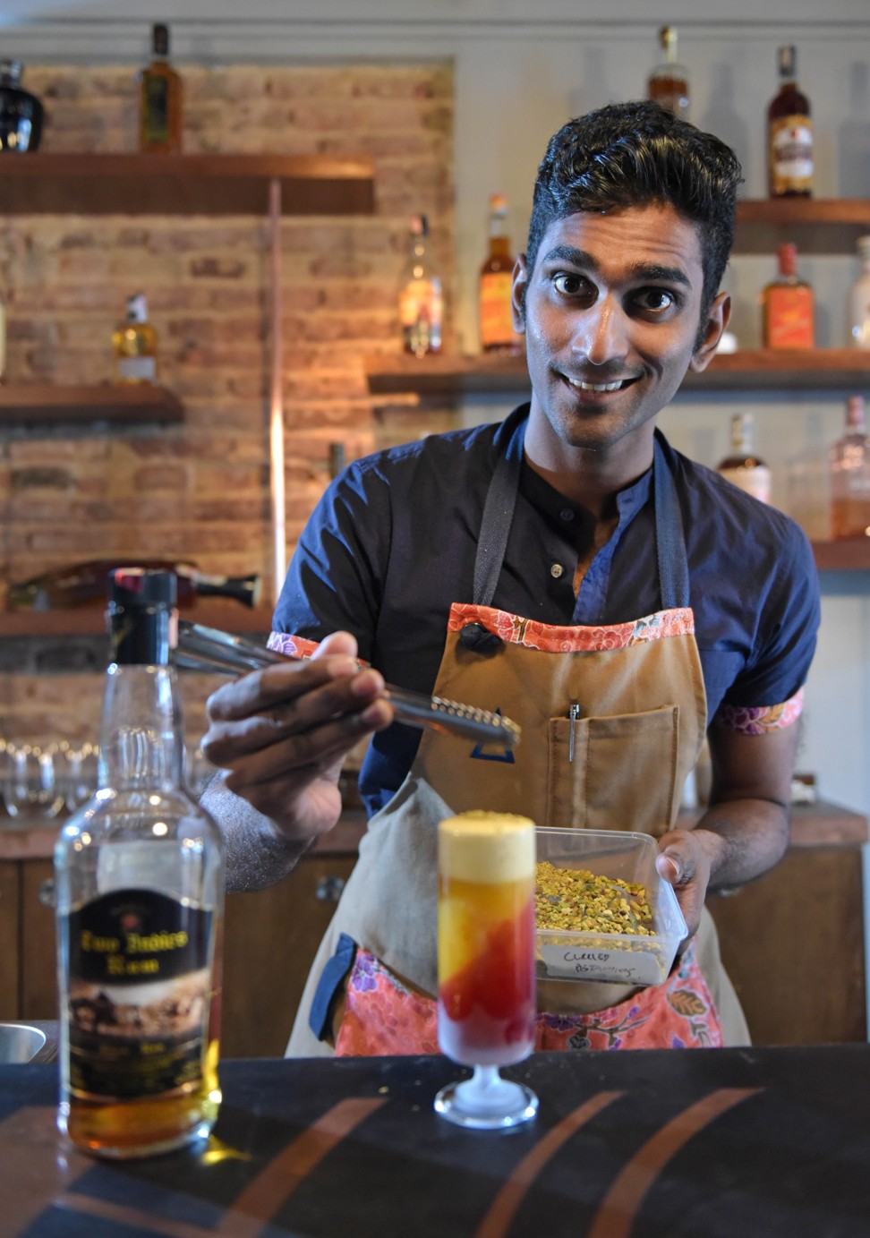 Vijay Mudaliar, head bartender of Native, preparing a Mango Lassi, which includes hand-puréed Indian mangoes, Amrut Old Port rum, beetroot jelly, pomegranate molasses and pistachios. Photo: The Straits Times