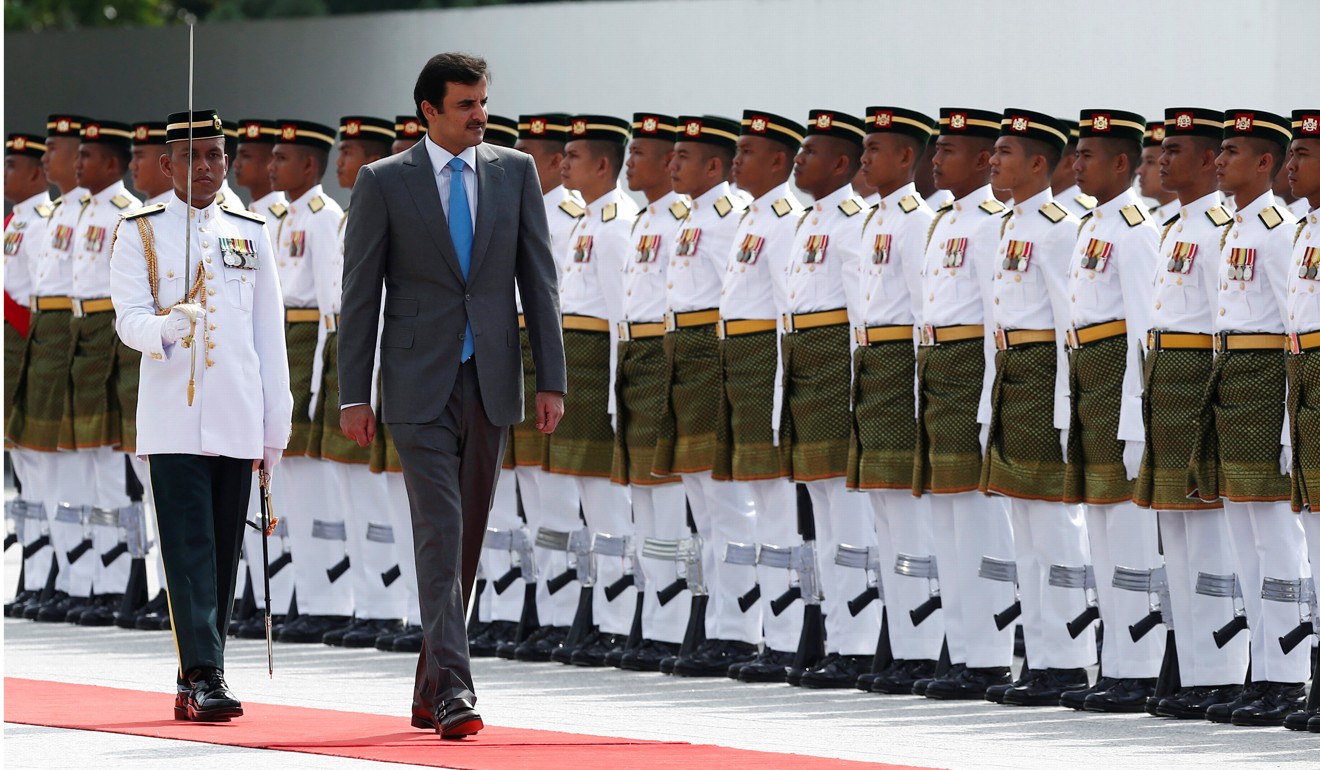 Qatar’s Emir Sheikh Tamim inspects an honour guard during a state welcoming ceremony at Parliament House in Kuala Lumpur. Photo: Reuters