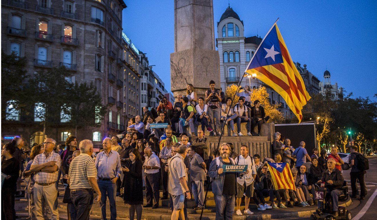 Protesters hold Catalan flags during a candlelight vigil to demand the release of imprisoned separatist leaders Jordi Sanchez. Photo: Bloomberg