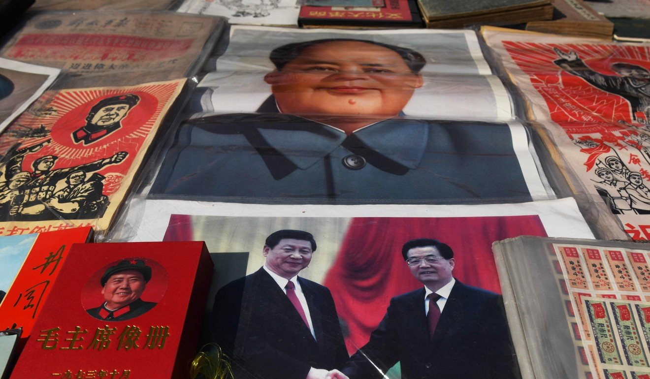 A photo of Xi Jinping with his predecessor Hu Jintao on sale at a market in Beijing along with pictures of Mao Zedong. Photo: AFP