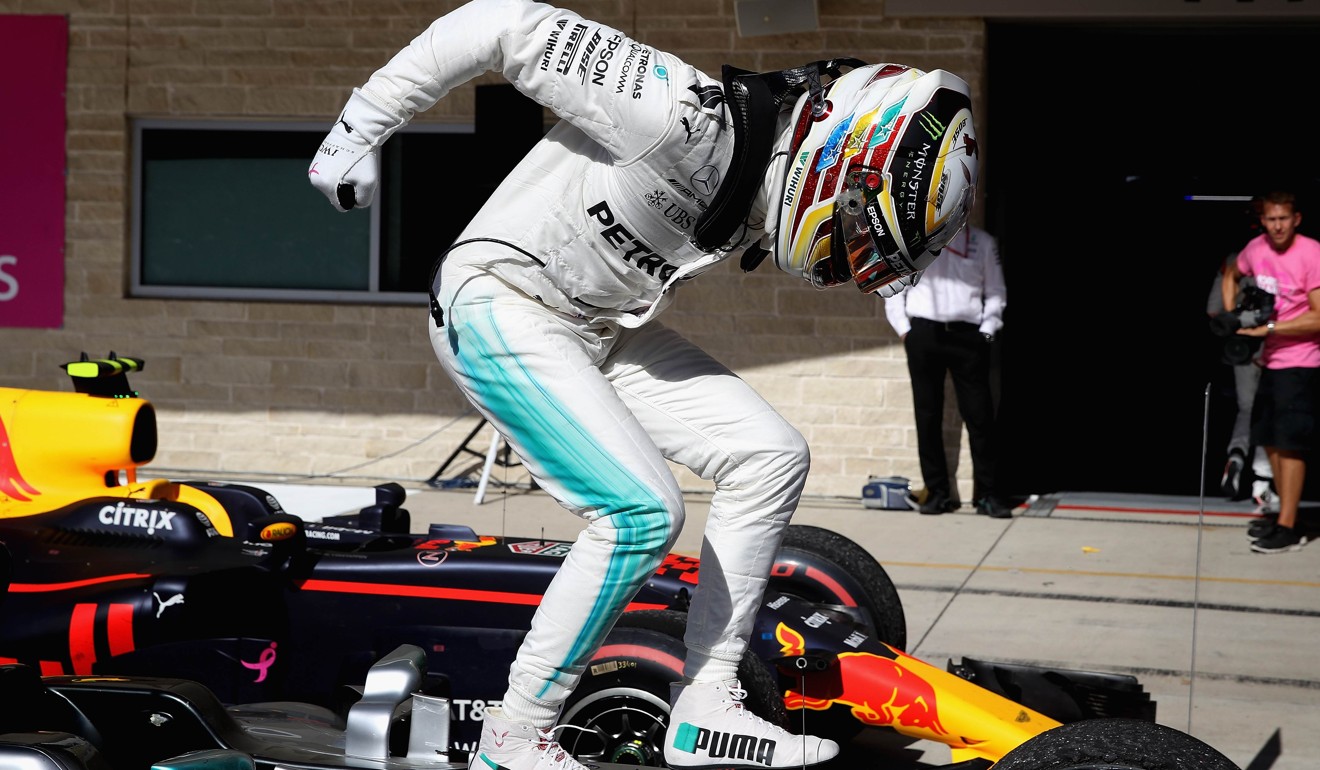 Lewis Hamilton celebrates in parc ferme at the US Grand Prix after stretching his drivers’ title lead to 66 points. Photo: AFP