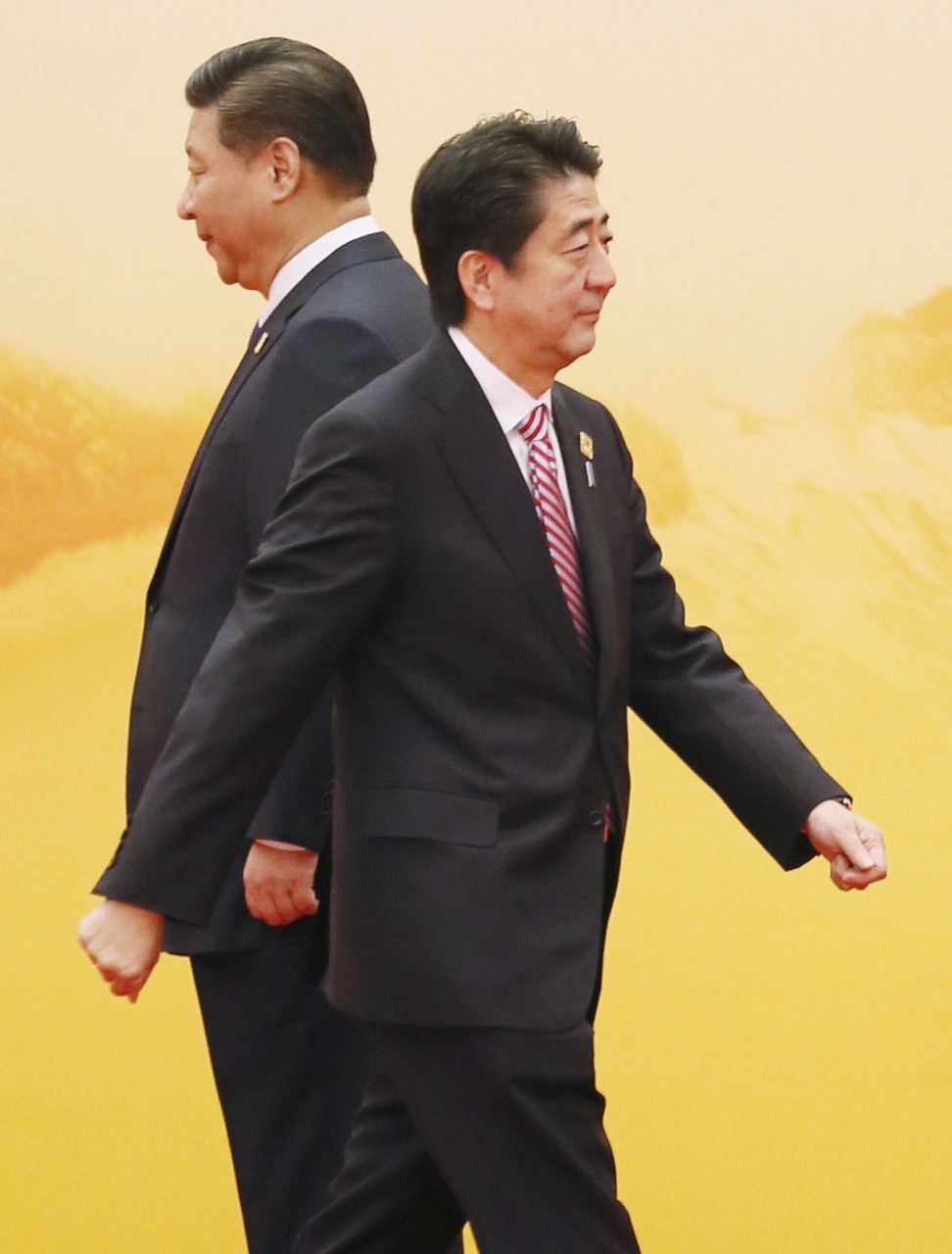 Japanese Prime Minister Shinzo Abe walks on after shaking hands with Chinese President Xi Jinping at the summit of Asia-Pacific Economic Cooperation forum in Beijing in 2014. In their most recent meeting in July this year, the two discussed their joint contribution towards affirming the stability and prosperity of Asia and the wider world, including, most significantly, through the belt and road. Photo: Kyodo