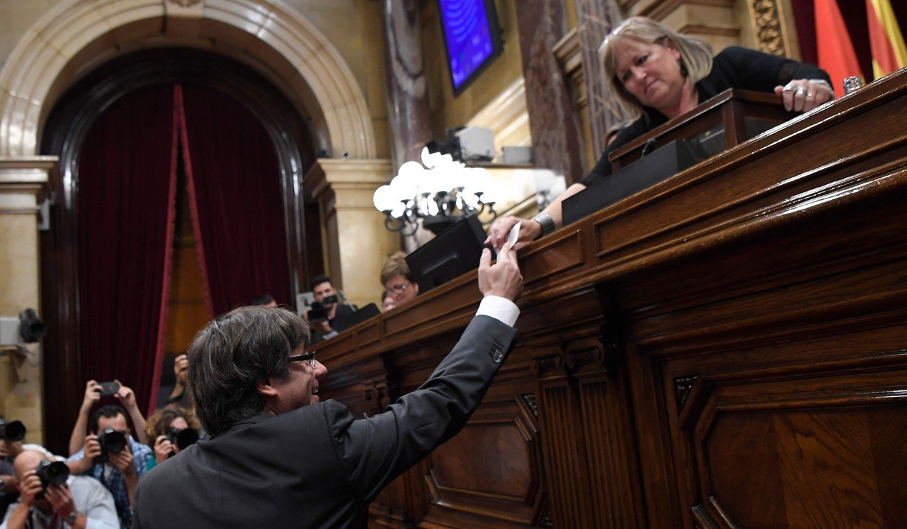 Puigdemont casts his vote for a motion on declaring independence from Spain. Photo: AFP