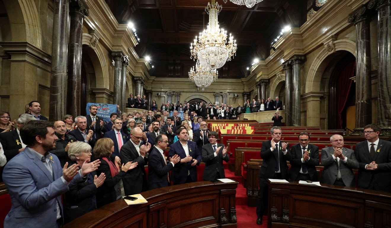 Catalan President Puigdemont and deputies applaud after the Catalan regional Parliament declared independence from Spain in Barcelona, Spain. Photo: Reuters