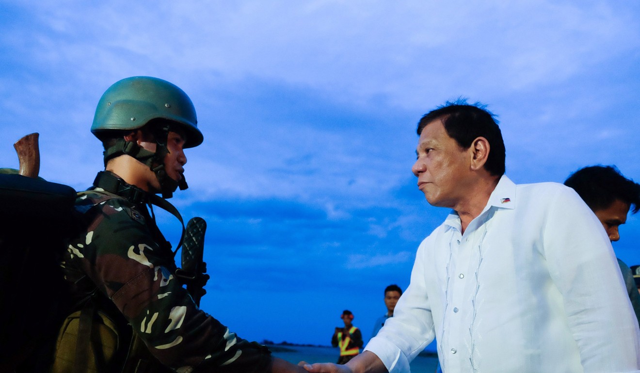 President Rodrigo Duterte greets troops returning from the frontline in Marawi. Photo: EPA-EFE