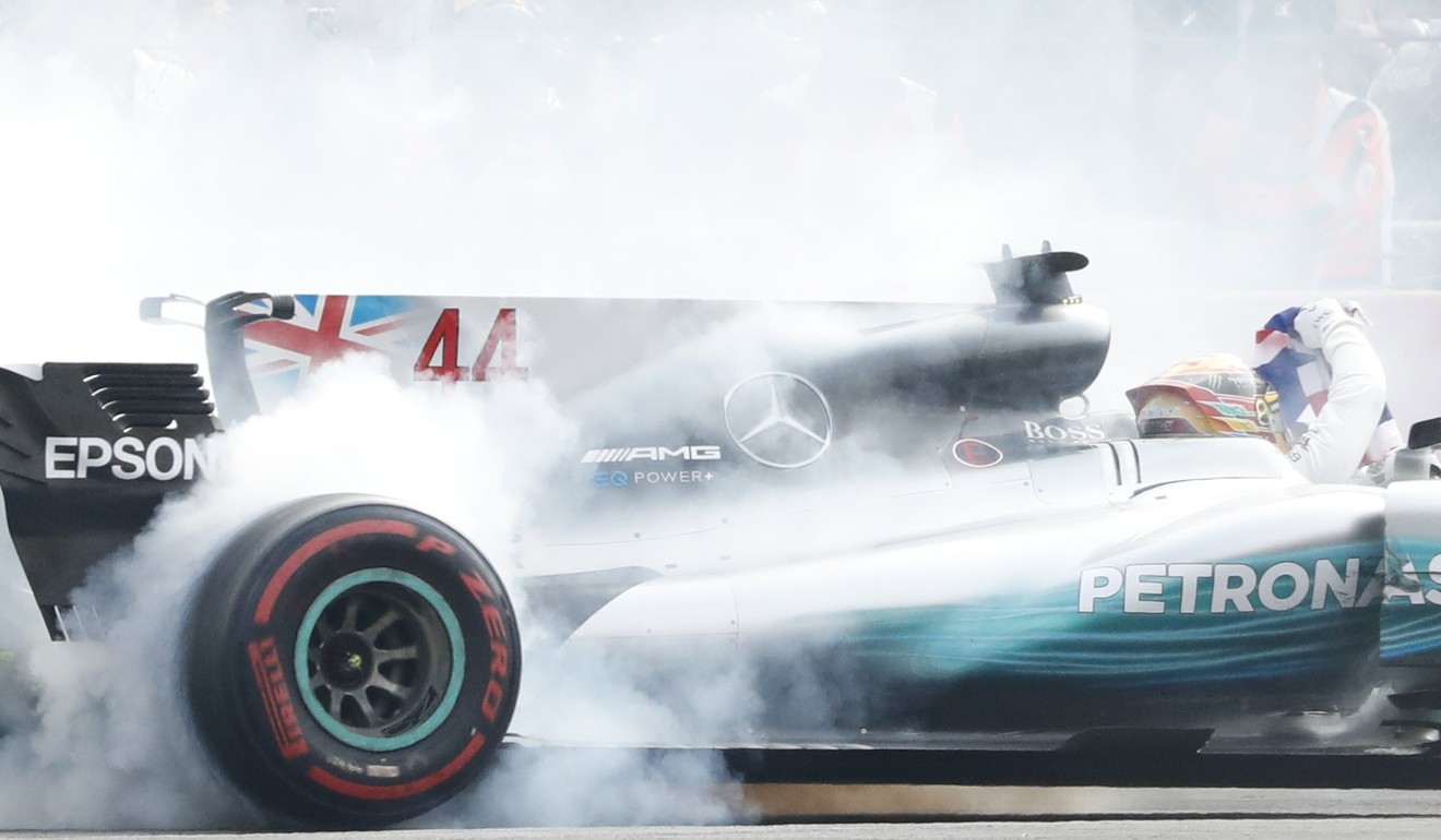 Lewis Hamilton delights the crowds with ‘doughnuts’. Photo: EPA