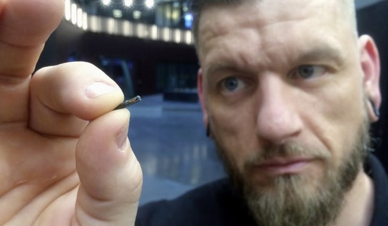 Jowan Osterlund from Biohax Sweden holds a small microchip implant, similar to those implanted into volunteers at the Australian Centre for the Moving Image. File photo: AP