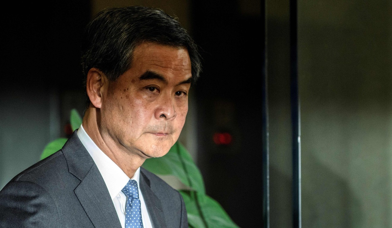 Leung Chun-ying leaves a courthouse after testifying against Avery Ng for throwing at sandwich at the city’s former leader. Photo: AFP