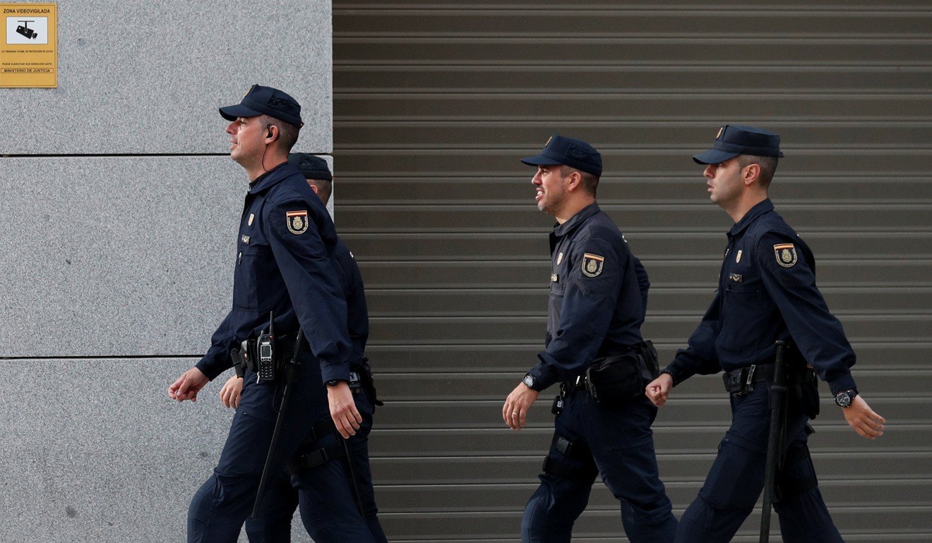 Spanish national police officers patrol outside Spain's High Court where dismissed Catalan government cabinet members were testifying on charges of rebellion, sedition and misuse of public funds. Photo: Reuters