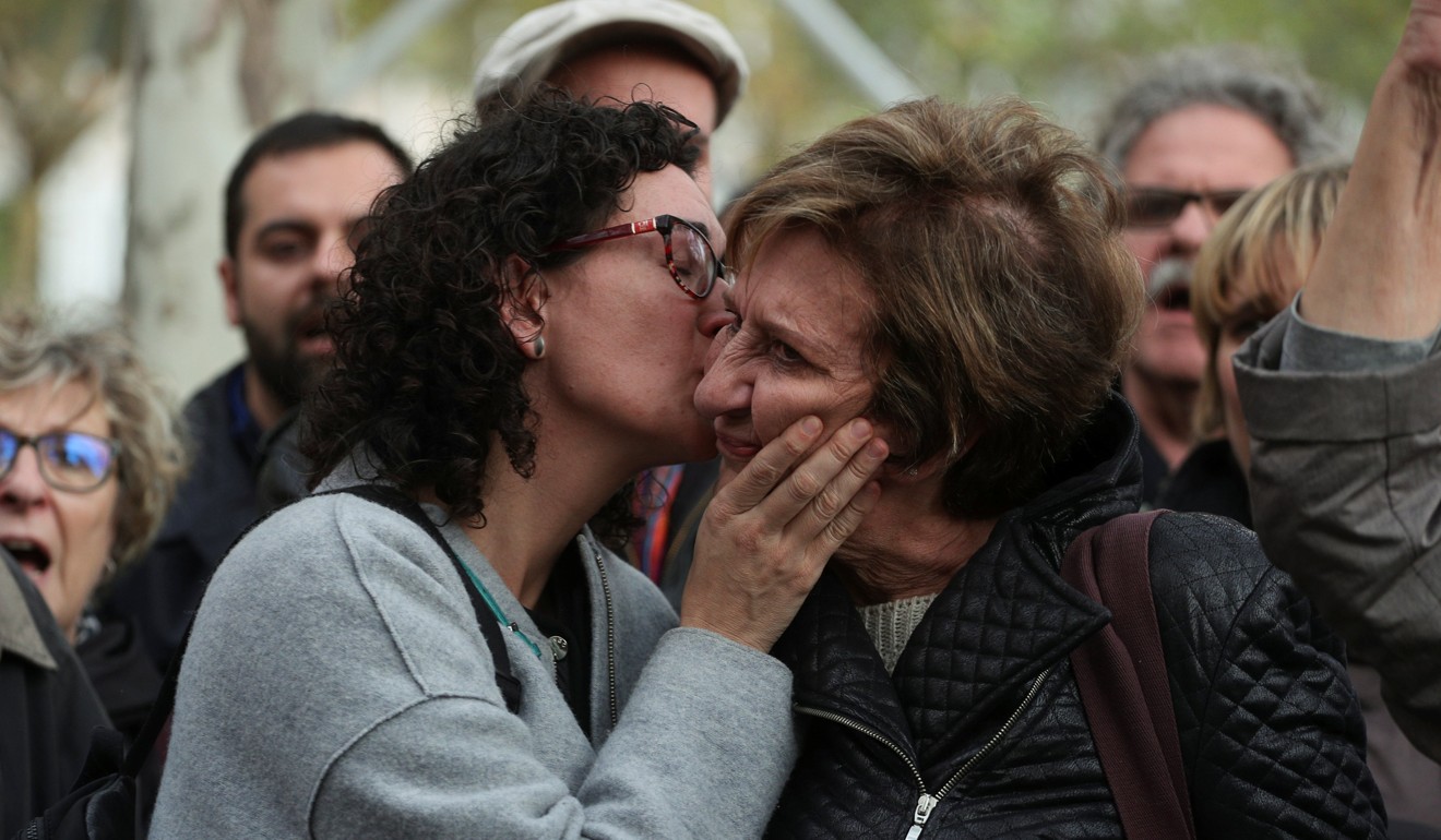 Supporters and family members of dismissed Catalan Cabinet members react outside Spain's High Court after a Spanish judge ordered the former Catalan leaders to be remanded in custody pending an investigation into Catalonia's independence push, in Madrid, Spain, on November 2, 2017. Photo: Reuters