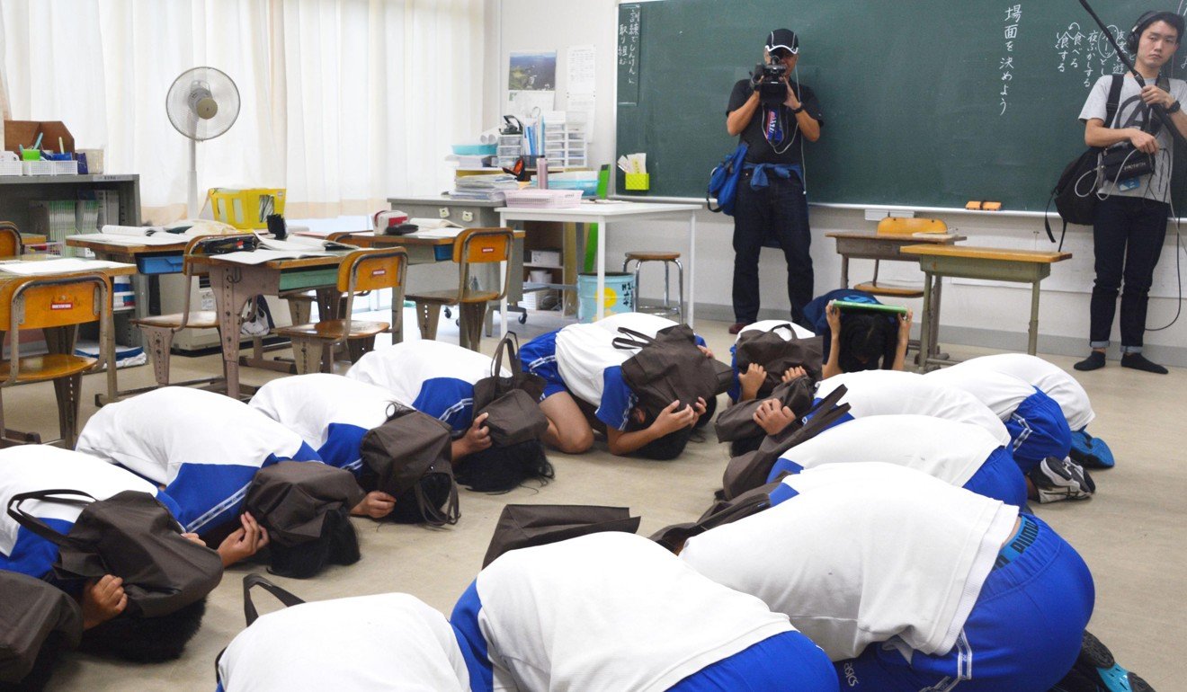 Junior school students practise an emergency drill in the western Japanese town of Okinoshima on September 6, in the wake of repeated missile launches by North Korea. Photo: Kyodo