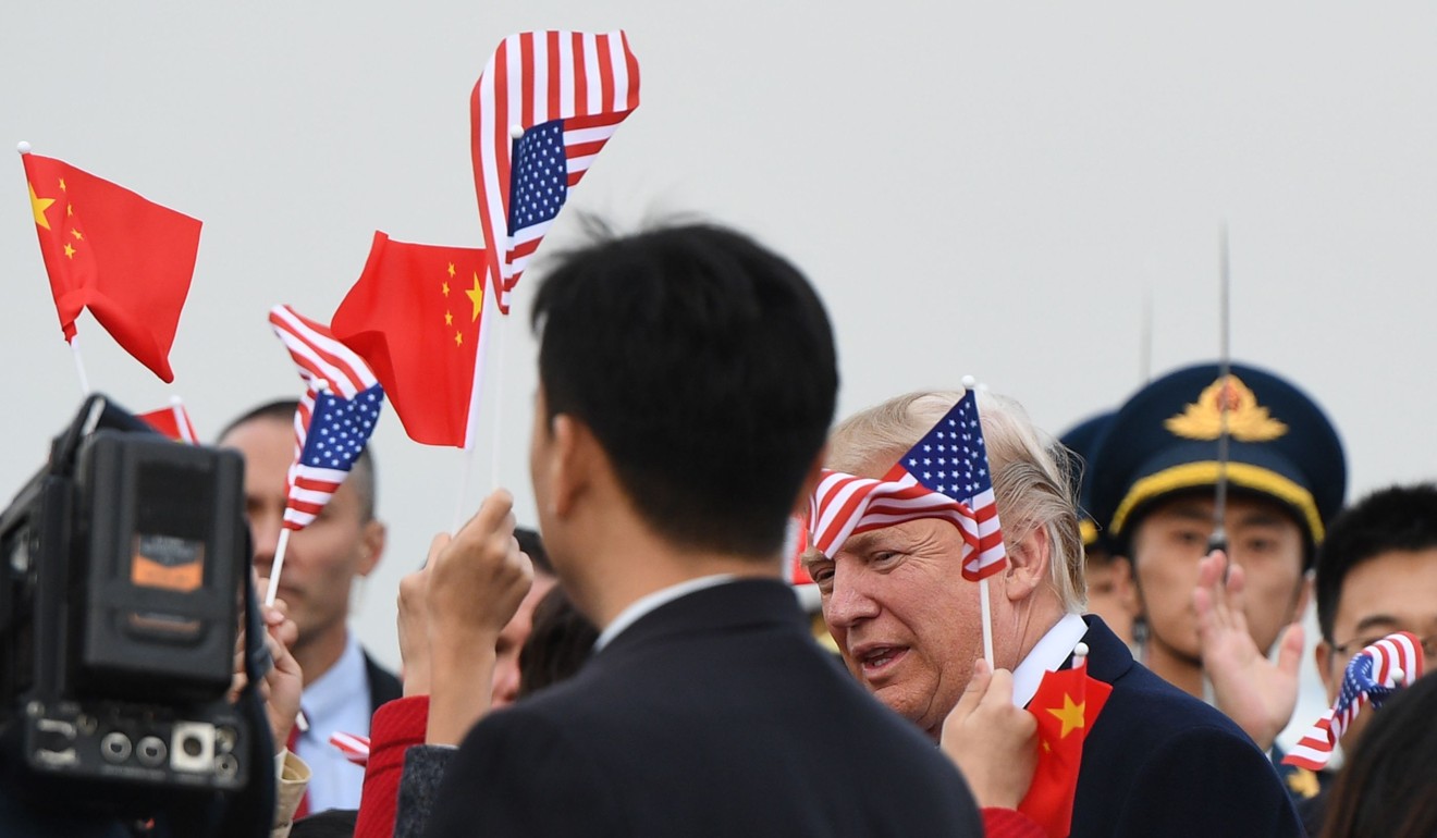 US President Donald Trump is greeted on arrival in Beijing. Photo: AFP