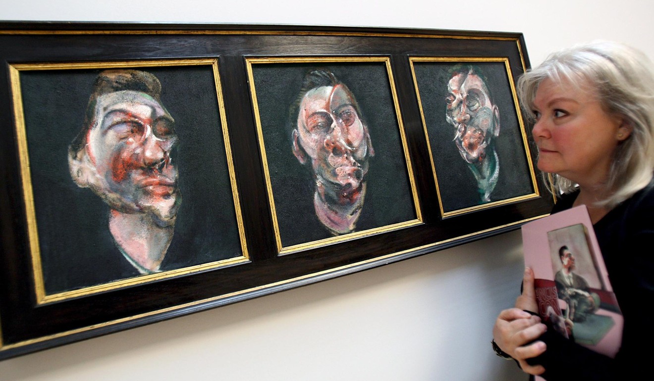 A woman looking at British artist Francis Bacon’s Three Studies for a Portrait of George Dyer,1963, at the Tate Britain in London. Photo: EPA