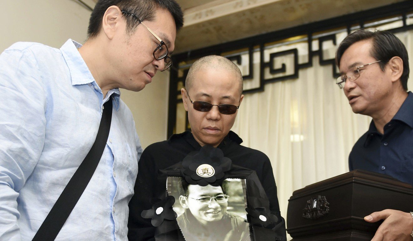 Nobel Peace Prize winner Liu Xiaobo’s widow, Liu Xia (centre) pictured at a funeral parlour after her husband’s death from cancer in July. Photo: Associated Press