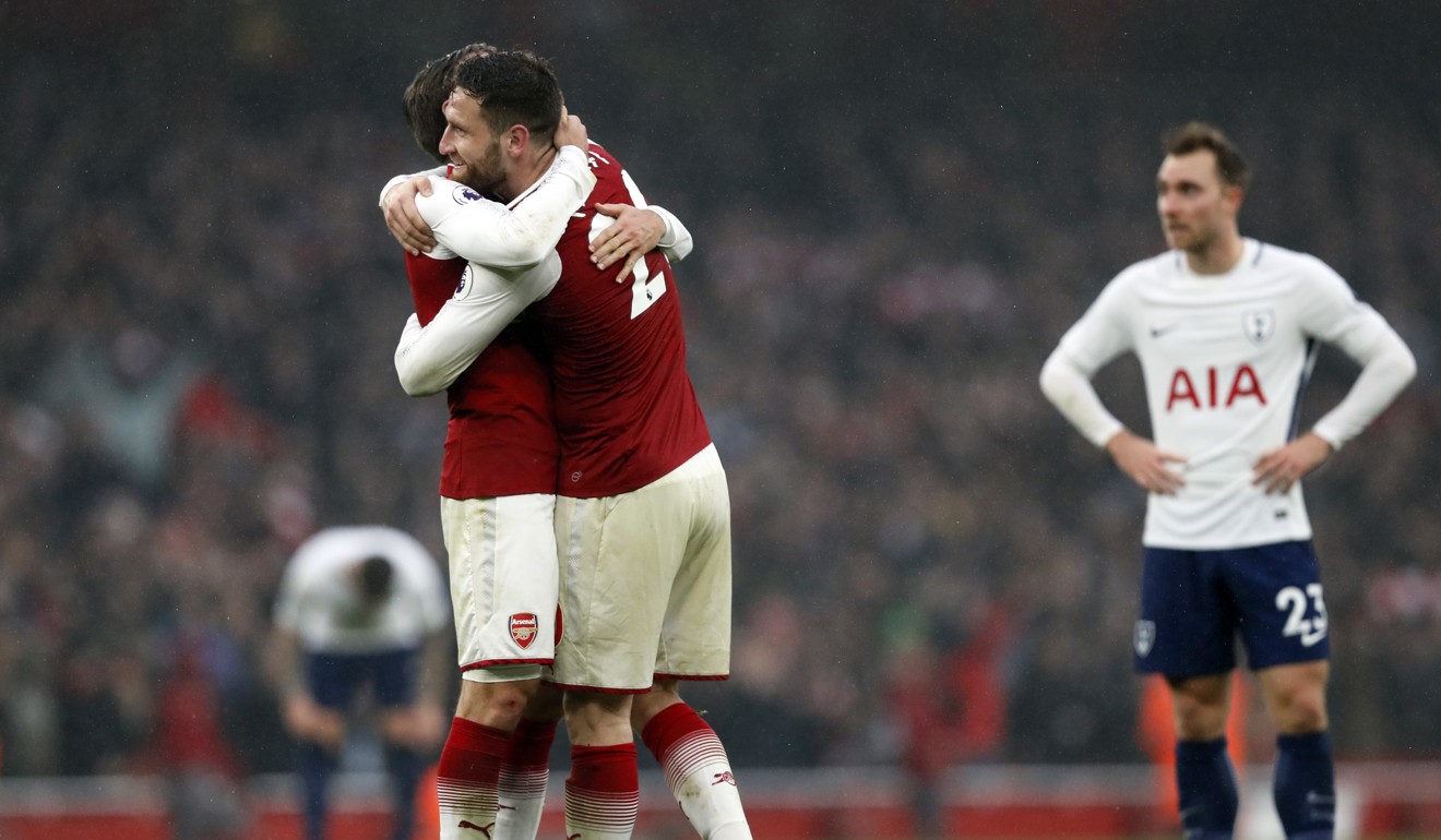 Arsenal's Shkodran Mustafi and teammate Nacho Monreal celebrate at the end of the match. Photo: AP