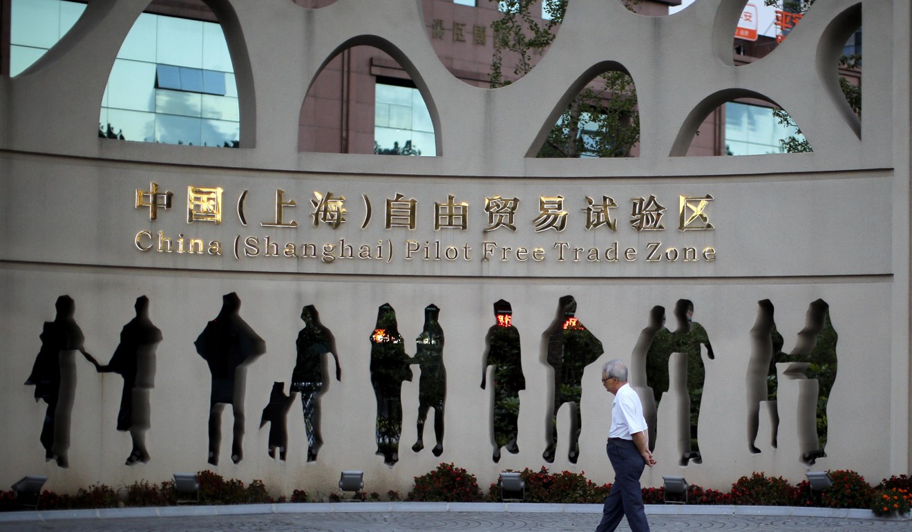 A man walking in front of an entrance to the Shanghai free-trade zone in Pudong. Photo: Reuters