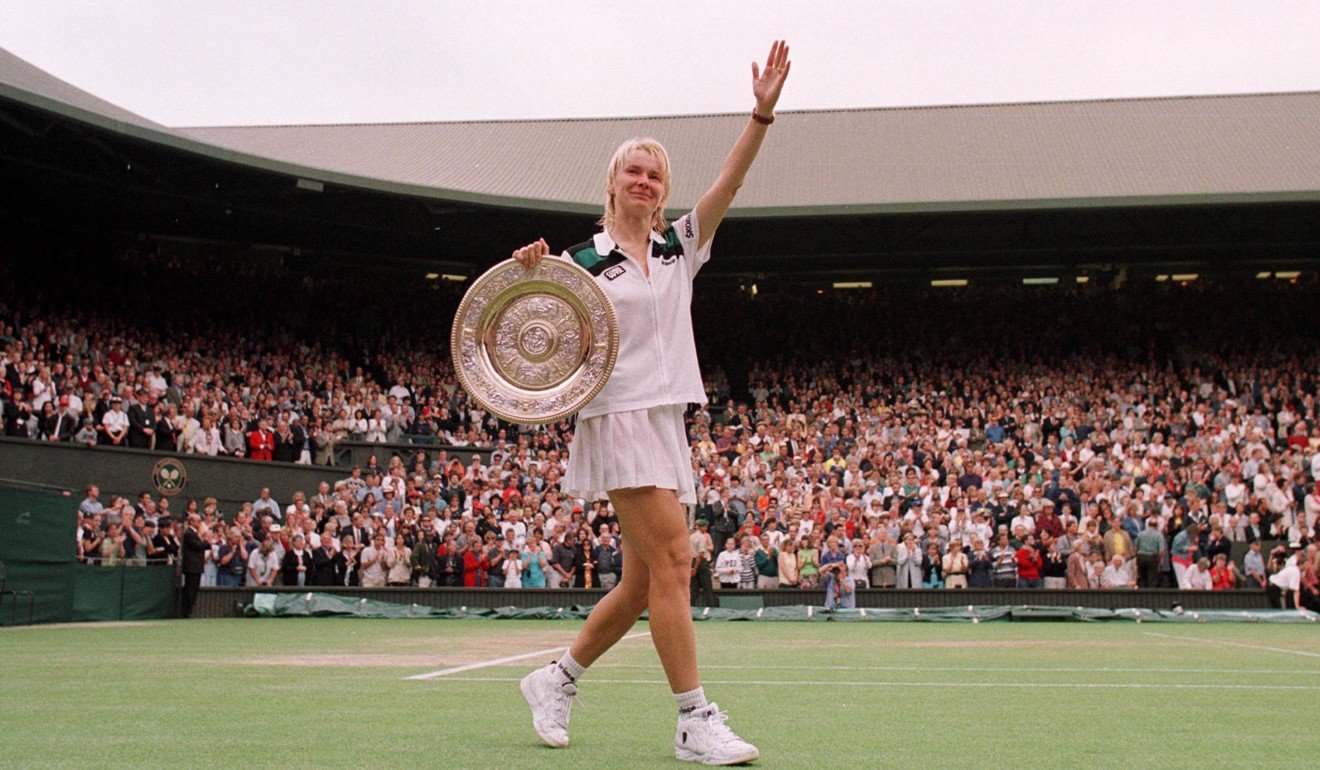 Jana Novotna waves to the crowd with her trophy after winning Wimbledon in 1998. Photo: Reuters