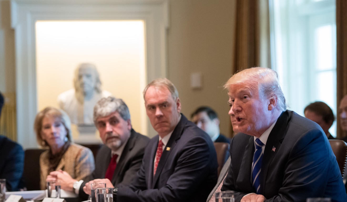 US President Donald Trump, right, speaks during a cabinet meeting at the White House. Photo: Pool via Bloomberg