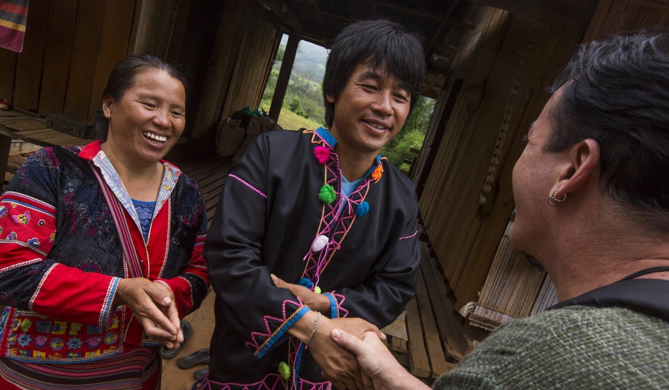 Local villagers welcome a traveller to their home in Pha Mon village, northern Thailand, where tourism offers an alternative source of income to farmers in the area. Photo: G Adventures