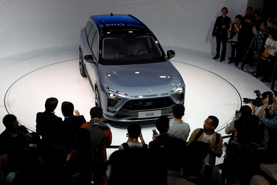 People gather at the booth of Chinese electric vehicle start-up Nio as it unveils its ES8 SUV at the Shanghai autoshow on April 19, 2017. Photo: REUTERS
