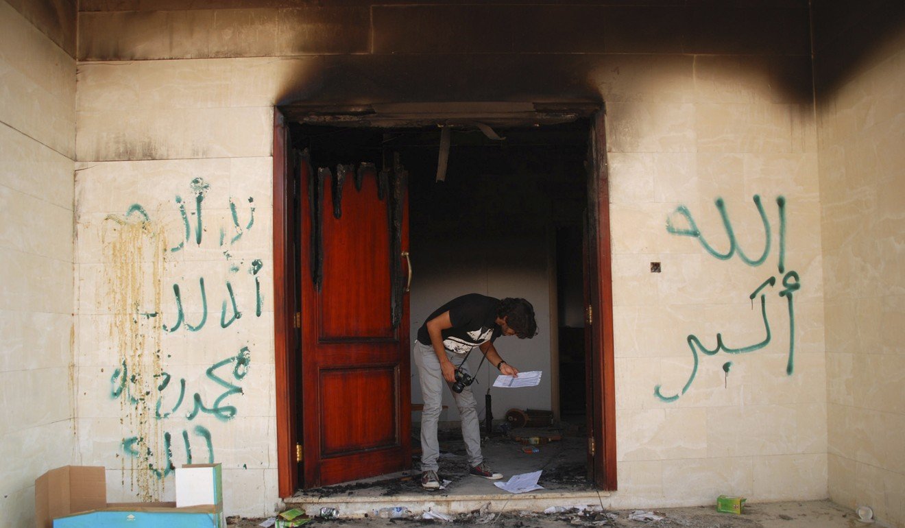 A man looks at documents at the charred US. Consulate in Benghazi, Libya, on September 12, 2012, the day after an attack that killed four Americans, including Ambassador Chris Stevens. Photo: AP