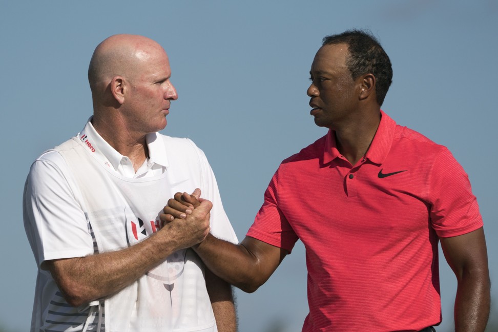 Woods shakes hands with caddie Joe LaCava. Photo: USA Today