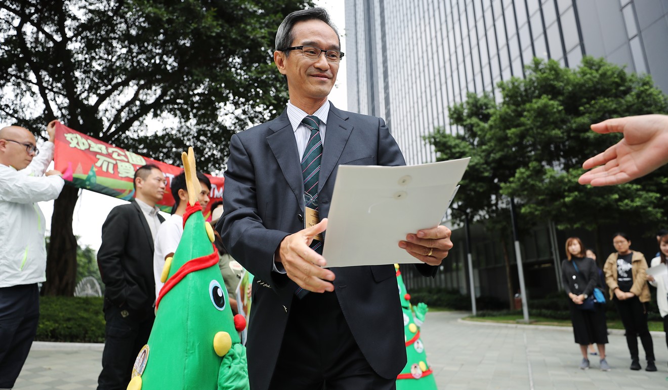 Task Force on Land Supply chairman Stanley Wong Yuen-fai receives a petition from Greenpeace calling on task force to safeguard country parks. Photo: Winson Wong