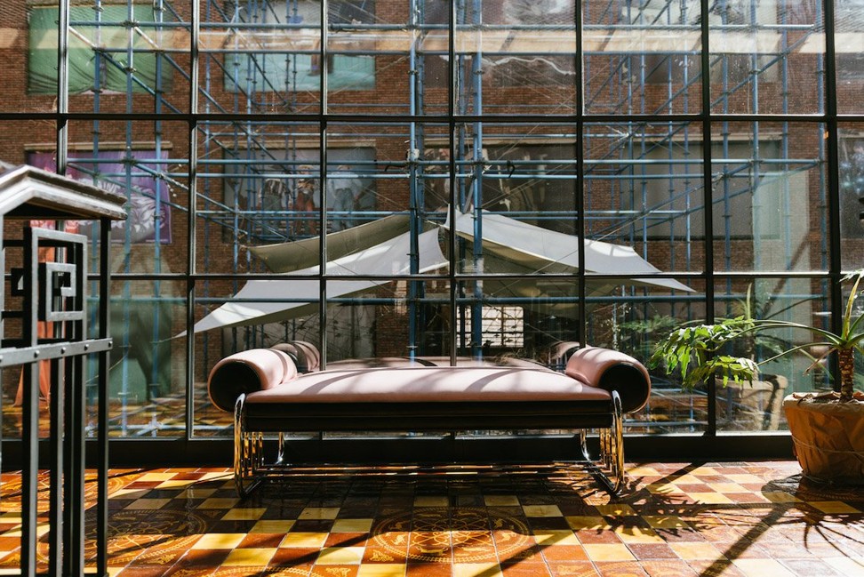 Shiny brass fittings, exposed wood and brick, and huge glass windows add to Rooms Hotel’s character.