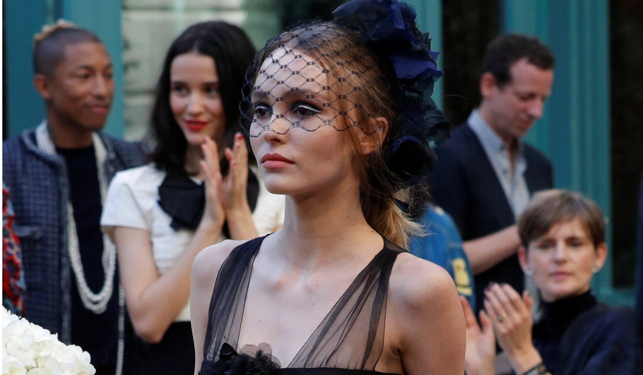 Actress Lily-Rose Depp presents a creation with a Paris Cosmopolite theme by designer Karl Lagerfeld during the Metiers d'Art Show for Chanel fashion house. Photo: REUTERS