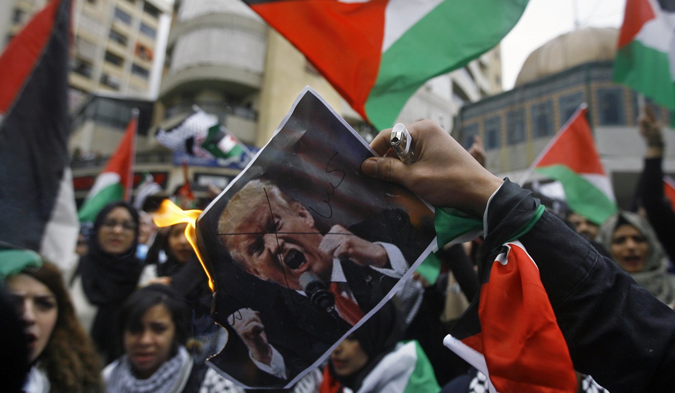 Lebanese and Palestinian students burn a poster of US President Donald Trump during protests over his decision to acknowledge Jerusalem as Israel’s capital. Photo: AP