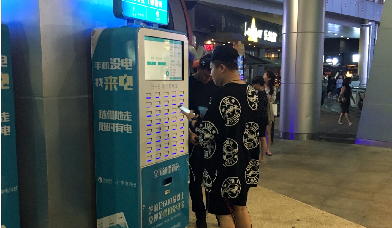 A man picks up a pay-as-you-go phone battery bank from Laidian Technology's vendor in Shenzhen. Photo: Yukin Pang, SCMP