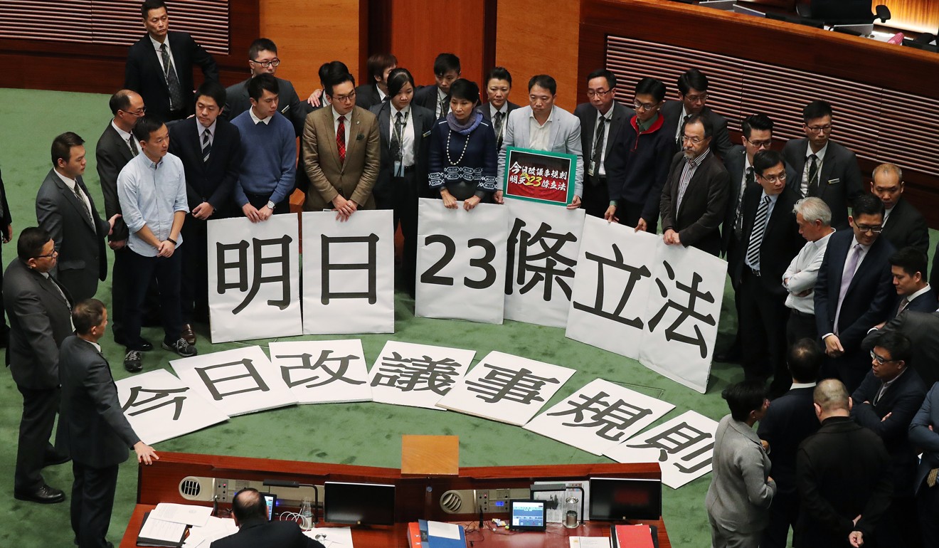 Pan-democrats protesting inside the chamber at an earlier Legco meeting. Photo: K. Y. Cheng