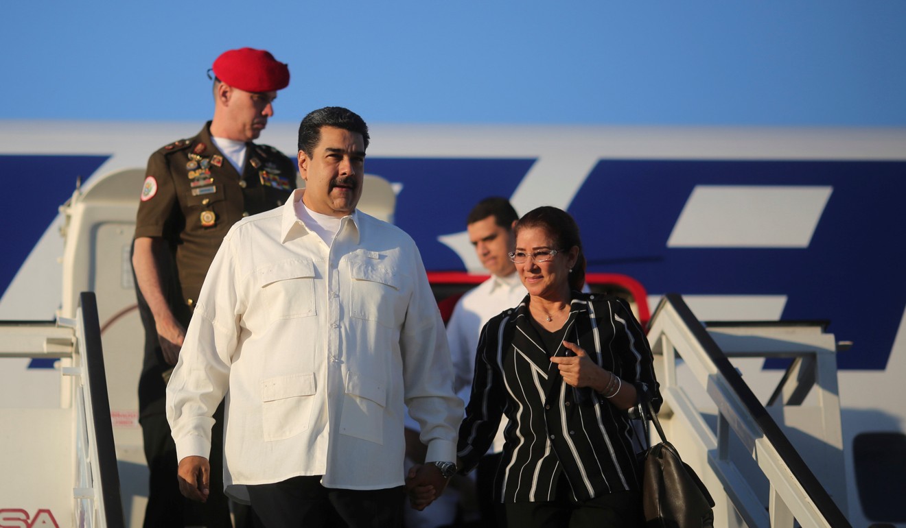 Venezuela’s President Nicolas Maduro and his wife Cilia Flores step out of their plane after arriving at Havana’s International Airport on Thursday. Photo: Reuters.