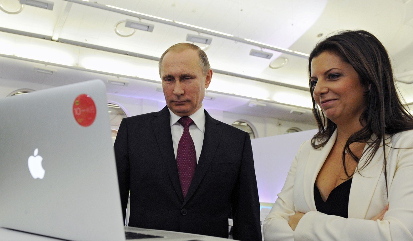 RT editor-in-chief Margarita Simonyan and Russian President Vladimir Putin attend an exhibition in Moscow two years ago marking the television network’s 10th anniversary. Photo: AP