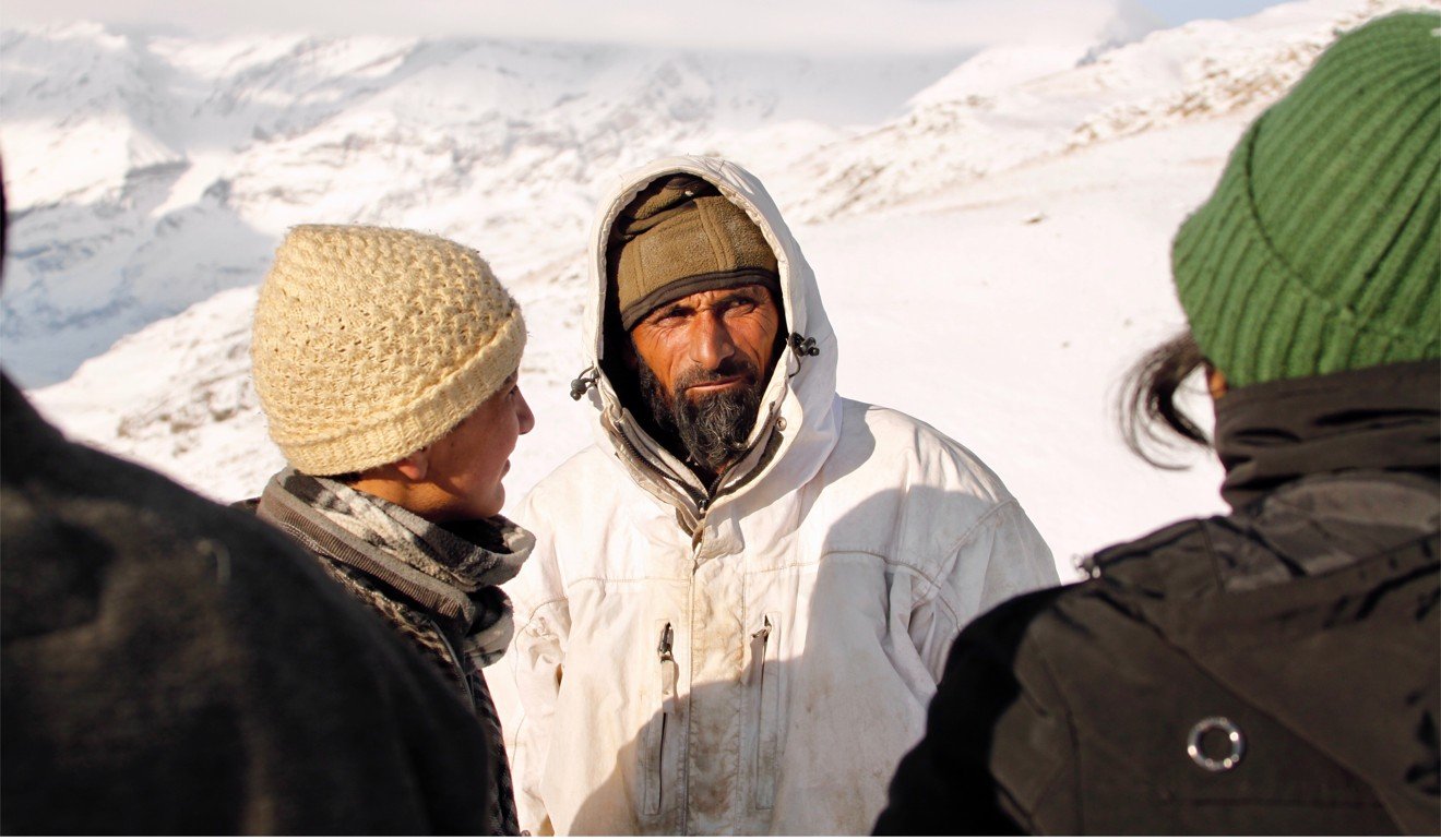 Local guide Kamal listens to instructions during the snowy expedition. Photo: Mark David Abbott