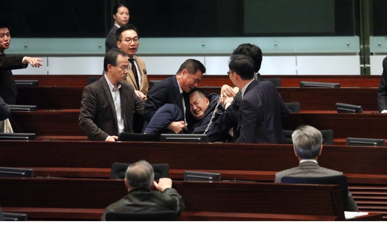 Lawmaker Raymond Chan Chi-chuen being removed from the Legislative Council chambers during a debate on proposed changes to Legco rules, on December 15. Hong Kong’s pan-democrats should learn to pick their battles. Photo: Felix Wong