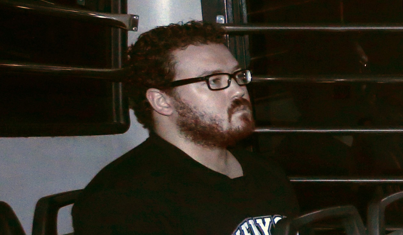 Rurik Jutting sits in the back row of a prison bus as he arrives at the Eastern Court in 2014. Photo: Reuters