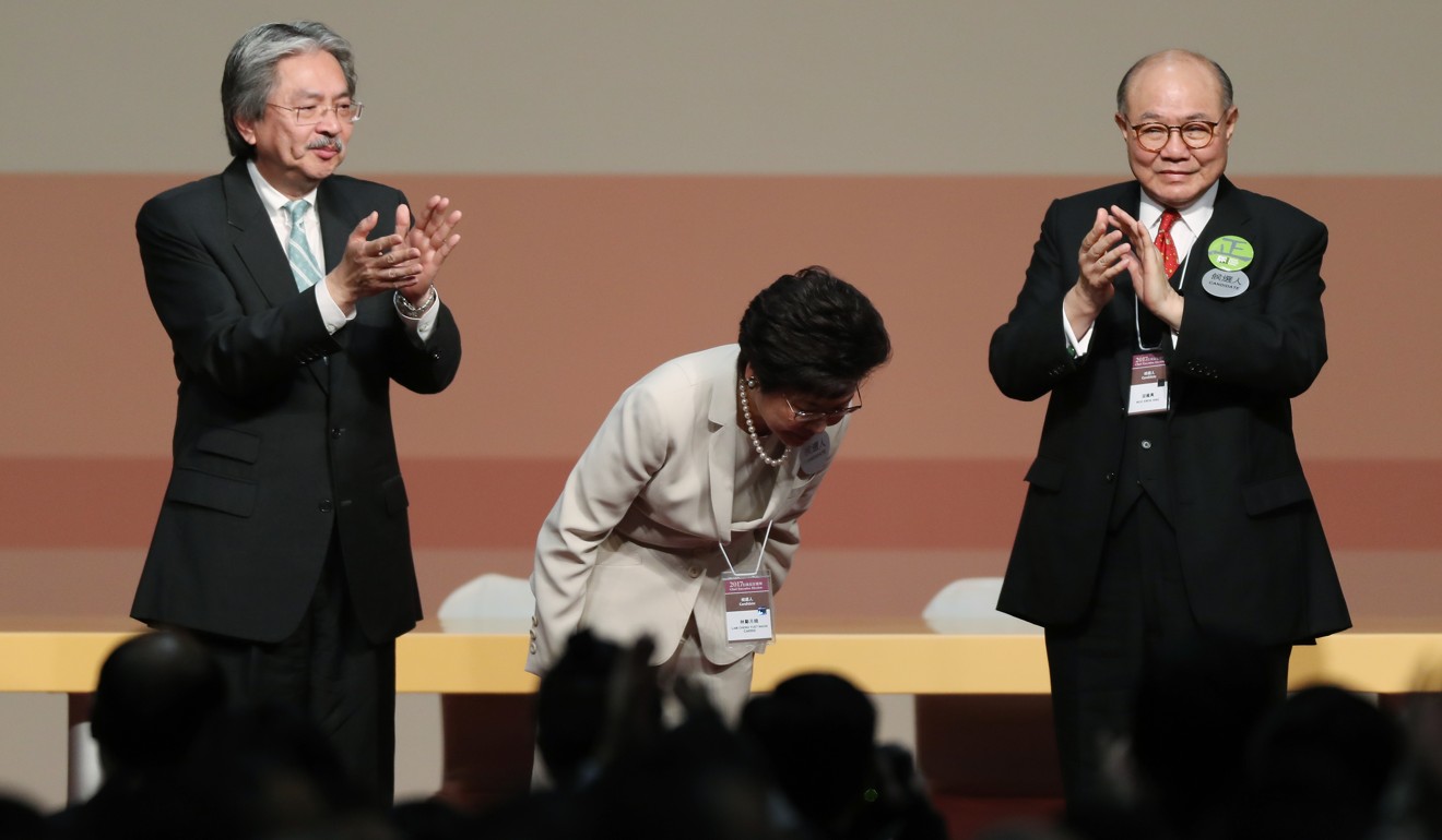 Carrie Lam (centre) bows during the announcement of her victory in the chief executive race, flanked by her competitors John Tsang (left) and Woo Kwok-hing (right). Photo: Robert Ng